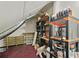 Finished attic space with storage shelves and equipment, offering potential for a workshop at 4505 Lakefield Bnd, Berkeley Lake, GA 30096