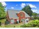 Brick home with a lawn, garden shed, and fenced perimeter at 4505 Lakefield Bnd, Berkeley Lake, GA 30096