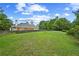 Expansive backyard featuring a lush lawn and mature trees at 4505 Lakefield Bnd, Berkeley Lake, GA 30096