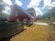 Charming two-story home featuring a fenced yard and a beautiful stone patio perfect for outdoor enjoyment at 4505 Lakefield Bnd, Berkeley Lake, GA 30096