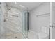 Bathroom featuring glass enclosed shower with luxurious marble tile and rainfall shower head at 4505 Lakefield Bnd, Berkeley Lake, GA 30096