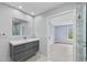 Modern bathroom featuring a stylish vanity and mirror with an ensuite access at 4505 Lakefield Bnd, Berkeley Lake, GA 30096