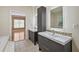 Stylish bathroom with double vanity, vessel sinks, decorative backsplash, and modern cabinets at 4505 Lakefield Bnd, Berkeley Lake, GA 30096