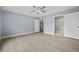 Spacious bedroom with neutral paint, wood floors, and ensuite bathroom access at 4505 Lakefield Bnd, Berkeley Lake, GA 30096