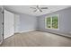 Inviting bedroom featuring neutral paint, natural light, and laminate wood flooring at 4505 Lakefield Bnd, Berkeley Lake, GA 30096