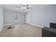 Bedroom features hardwood floors, a ceiling fan, neutral paint and a large window at 4505 Lakefield Bnd, Berkeley Lake, GA 30096