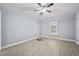 Bedroom features hardwood floors, a ceiling fan, neutral paint and a large window at 4505 Lakefield Bnd, Berkeley Lake, GA 30096