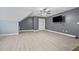 Bedroom with hardwood floors, a ceiling fan, neutral paint, and mounted TV at 4505 Lakefield Bnd, Berkeley Lake, GA 30096