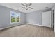 Bright bedroom featuring neutral paint, natural light, and laminate wood flooring at 4505 Lakefield Bnd, Berkeley Lake, GA 30096