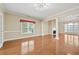Bright dining room with hardwood floors, elegant lighting, and view of the fireplace at 4505 Lakefield Bnd, Berkeley Lake, GA 30096