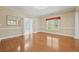 Dining room with hardwood floors, elegant lighting, and french doors at 4505 Lakefield Bnd, Berkeley Lake, GA 30096
