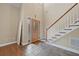 Front foyer featuring a staircase, tile flooring and a stained-glass front door at 4505 Lakefield Bnd, Berkeley Lake, GA 30096