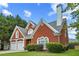 Beautiful brick home featuring a two-car garage and manicured landscaping at 4505 Lakefield Bnd, Berkeley Lake, GA 30096