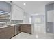 Bright kitchen featuring stainless steel appliances, marble counters and tile floors at 4505 Lakefield Bnd, Berkeley Lake, GA 30096