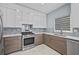 Contemporary kitchen featuring stainless steel appliances, modern tile backsplash, and marble countertops at 4505 Lakefield Bnd, Berkeley Lake, GA 30096