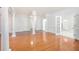 Open-concept living room featuring hardwood floors, large columns, and lots of natural light at 4505 Lakefield Bnd, Berkeley Lake, GA 30096