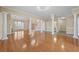 Open living area featuring hardwood floors, stately columns, and lots of light at 4505 Lakefield Bnd, Berkeley Lake, GA 30096