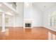 Bright living room featuring high ceilings, a fireplace, and hardwood floors at 4505 Lakefield Bnd, Berkeley Lake, GA 30096