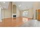 Expansive living area with a fireplace, lots of light, hardwood floors and large windows at 4505 Lakefield Bnd, Berkeley Lake, GA 30096