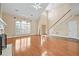 Bright living space featuring high ceilings, hardwood floors, a staircase and large windows at 4505 Lakefield Bnd, Berkeley Lake, GA 30096