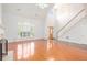 Bright open-concept living room with hardwood floors, high ceilings, and a staircase at 4505 Lakefield Bnd, Berkeley Lake, GA 30096