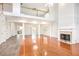 Open-concept living room with tall ceilings, a fireplace, and a balcony at 4505 Lakefield Bnd, Berkeley Lake, GA 30096