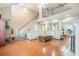 Spacious living room with soaring ceilings, a fireplace, and staircase at 4505 Lakefield Bnd, Berkeley Lake, GA 30096