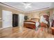 Serene main bedroom with hardwood floors, tray ceiling, and ensuite bathroom access at 4505 Lakefield Bnd, Berkeley Lake, GA 30096