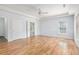 Spacious main bedroom with hardwood floors, tray ceilings, and a ceiling fan at 4505 Lakefield Bnd, Berkeley Lake, GA 30096