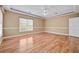 Large bedroom with hardwood floors, white trim, and natural light from the window at 4505 Lakefield Bnd, Berkeley Lake, GA 30096