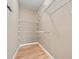 Functional walk-in closet with wire shelving and wood-look flooring at 4505 Lakefield Bnd, Berkeley Lake, GA 30096