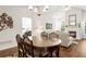 Open concept dining room with hardwood floors, chandelier, and views to the living room with fireplace at 4573 Caleb Xing # 20, Powder Springs, GA 30127