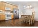 Well-lit eat-in kitchen boasts light wood cabinetry, stainless steel appliances, and space for a dining table at 4573 Caleb Xing # 20, Powder Springs, GA 30127