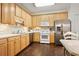 Bright kitchen features light wood cabinetry, stainless steel appliances, and eat-in dining area at 4573 Caleb Xing # 20, Powder Springs, GA 30127