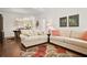 Bright living room with hardwood floors, neutral furniture, and an open layout to the dining area at 4573 Caleb Xing # 20, Powder Springs, GA 30127