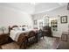 Cozy main bedroom featuring a decorative ceiling, large window, and classic wood furniture at 4573 Caleb Xing # 20, Powder Springs, GA 30127