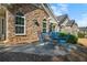 Stone house patio with attractive blue metal furniture and views of greenery in the backyard at 4573 Caleb Xing # 20, Powder Springs, GA 30127