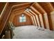 Spacious attic featuring wood paneling, rafters and abundant natural light from the double windows at 313 Ellenwood Dr, Bowdon, GA 30108