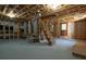 Unfinished basement with exposed ceiling, stairs, concrete walls, painted floors, and lots of potential at 313 Ellenwood Dr, Bowdon, GA 30108