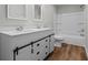 Charming bathroom features a white double vanity, modern accents, and shower-tub combo at 313 Ellenwood Dr, Bowdon, GA 30108