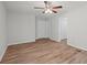 Cozy bedroom with ceiling fan, neutral walls, and laminate wood flooring at 313 Ellenwood Dr, Bowdon, GA 30108