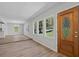 Bright entryway with hardwood floors and a decorative front door that leads into the living space and kitchen at 313 Ellenwood Dr, Bowdon, GA 30108