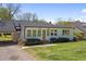 Charming home with manicured lawn, a covered parking area, and a welcoming front entrance at 313 Ellenwood Dr, Bowdon, GA 30108