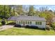 Charming home featuring a well-manicured lawn, a carport, and a front porch at 313 Ellenwood Dr, Bowdon, GA 30108