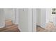 Hallway with wood floors leading to bedrooms, closets, and a bathroom at 313 Ellenwood Dr, Bowdon, GA 30108