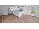 Bright, open-concept kitchen with modern stainless steel appliances, a central island, and updated lighting fixtures at 313 Ellenwood Dr, Bowdon, GA 30108