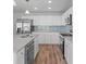 Bright kitchen boasts granite counters, stainless appliances, and ample white cabinetry at 313 Ellenwood Dr, Bowdon, GA 30108