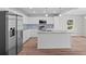 Bright kitchen features stainless steel appliances, modern cabinets, granite countertops, and a large island at 313 Ellenwood Dr, Bowdon, GA 30108