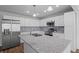 Modern kitchen with stainless steel appliances, white cabinets, and granite countertops at 313 Ellenwood Dr, Bowdon, GA 30108
