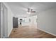 Open-concept living space with wood floors, leading into a bright and airy kitchen at 313 Ellenwood Dr, Bowdon, GA 30108